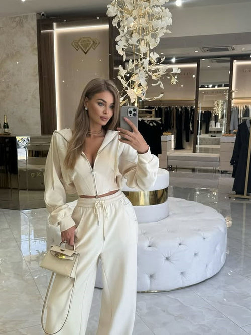 Noir Riviera cinched waist zip hoodie sweatsuit set, styled lifestyle shot with phone and purse